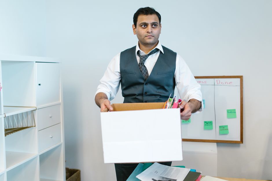 Someone carrying a box while moving premises
