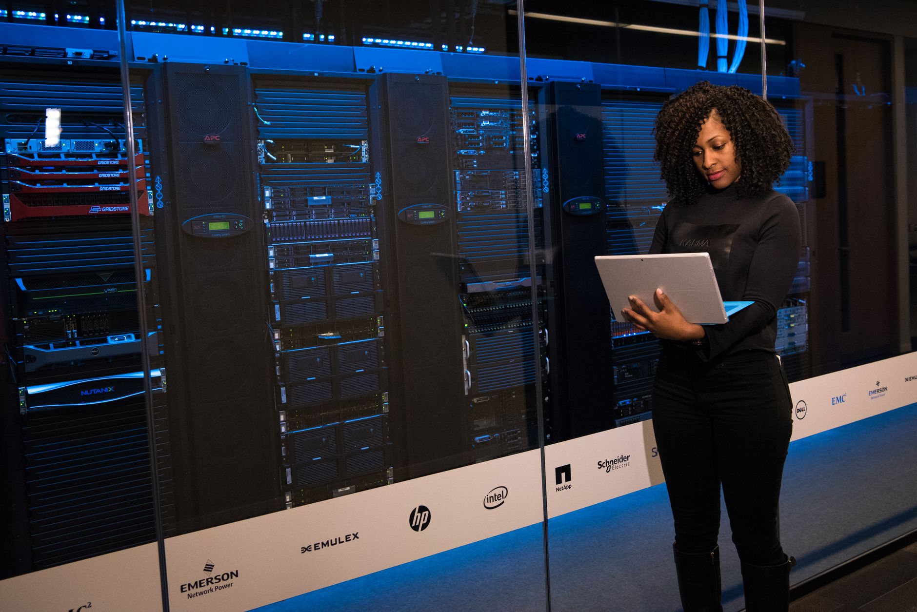 An engineer working beside server racks