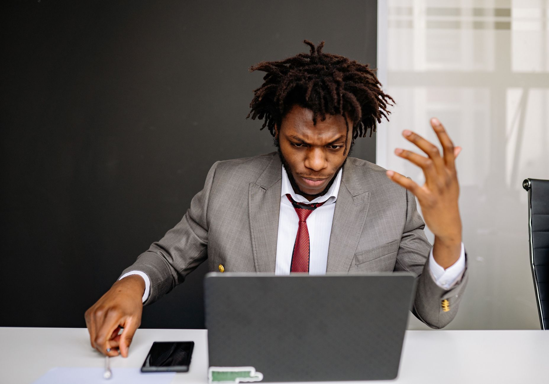 A worried person at a computer dealing with a problem