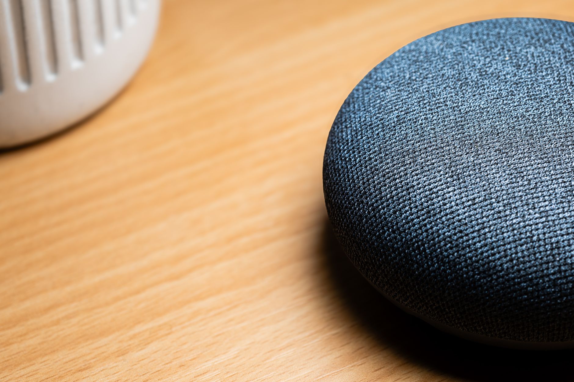 A smart speaker on a wooden table