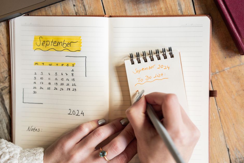 Someone planning in a notebook at a desk